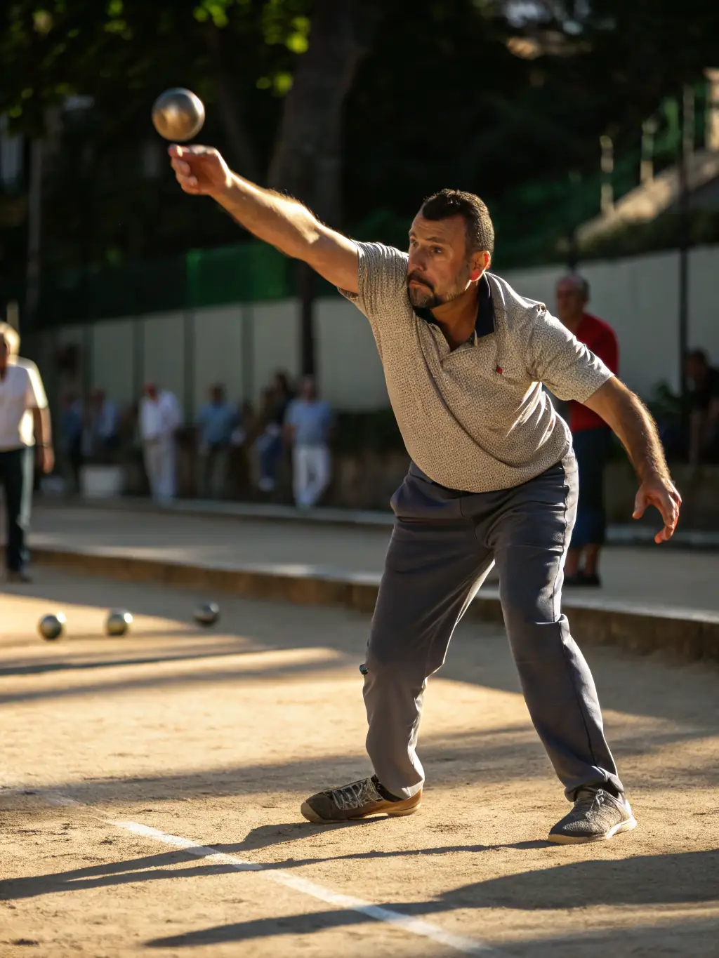 A focused shot of a boule player carefully aiming during a training session at CLUB BOULISTE DU BRIENNOIS, showcasing the precision and concentration involved in the sport.